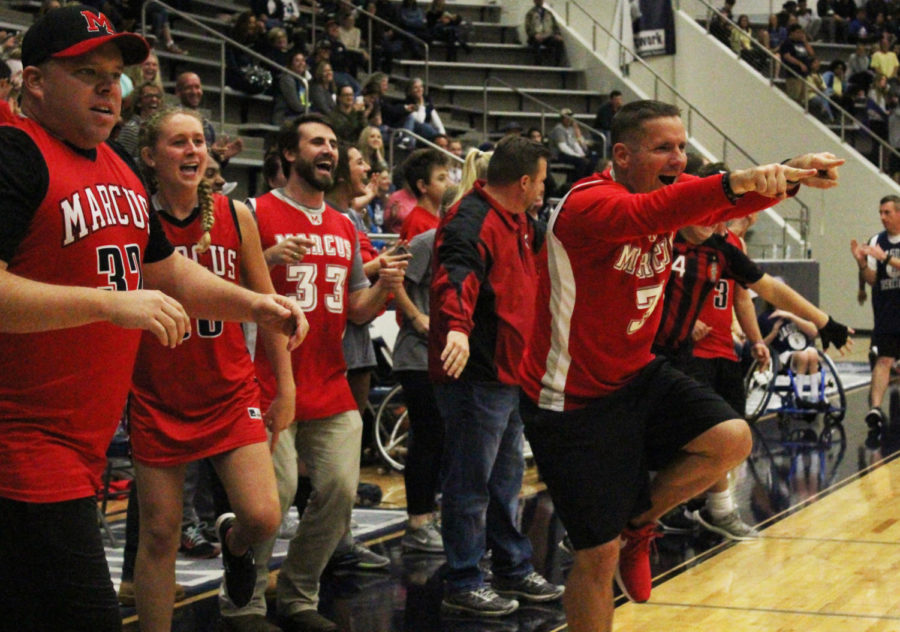 SRO Mike Anderson and Head Athletic Director Kevin Atkinson cheer on their team during a late game comeback. The Marauders overcame Flower Mound’s 13-point lead in the first half of the game to secure the victory by one point. 