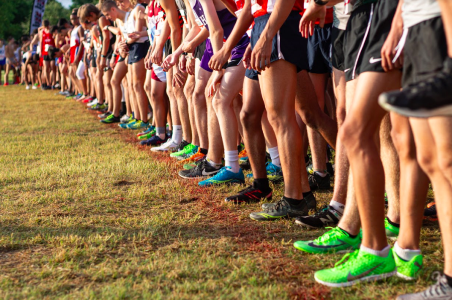 The runners anxiously waited for the sound of the starters pistol to signal their turn to go. 