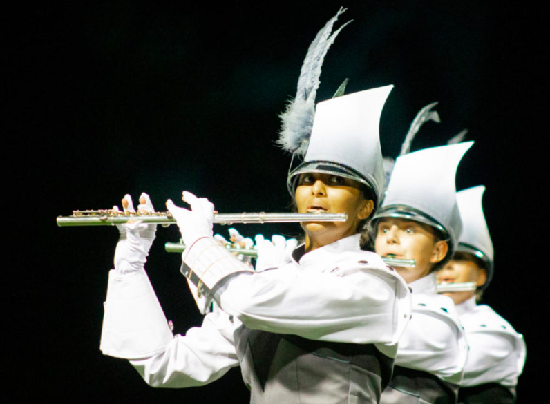 Senior Riya Bhuta watches her fellow band members as she focuses on playing the flute in time with the other musicians. 