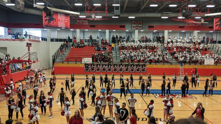 The cheerleaders and Marquettes prepare to greet the spring sport athletes onto the basketball court at a pep rally on Feb. 19.