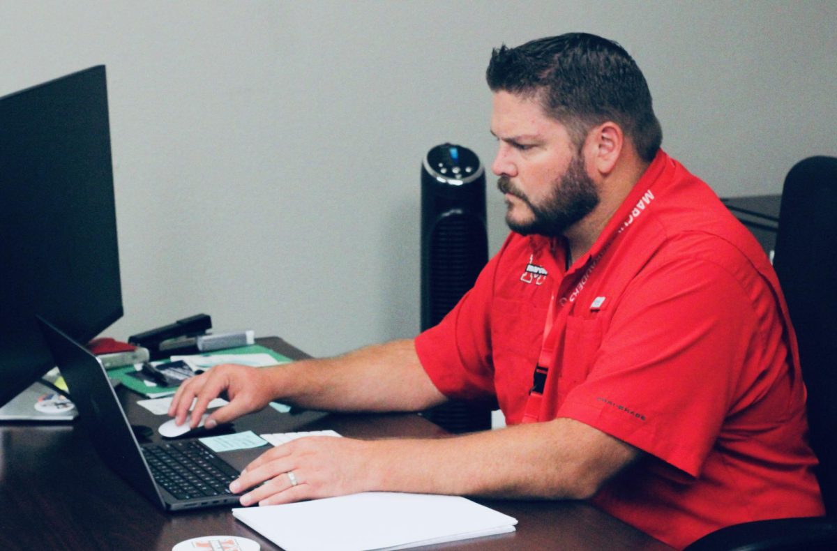 Dr. Koontz prepares for the school day in his office at Marcus High.