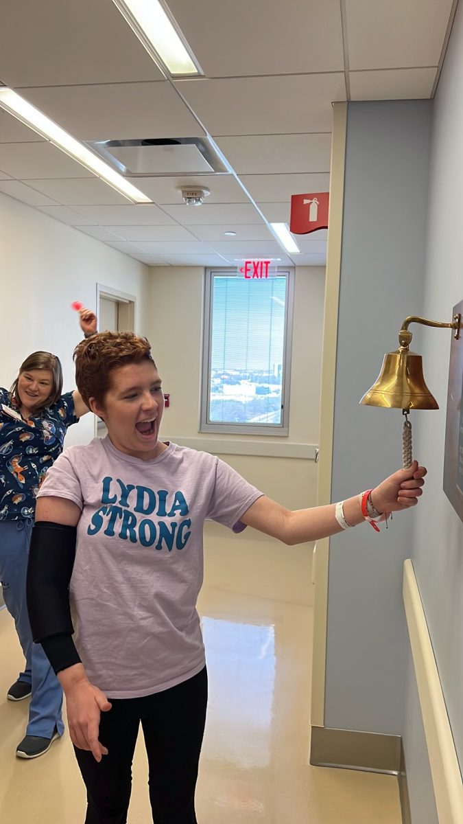 Lydia rings the golden bell to celebrate her winning tough fight with cancer. 