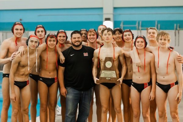 Principal Dr. Koontz celebrates with the Men's Water Polo team after their 17-12 victory over Southlake Carroll on Saturday, Oct. 19.