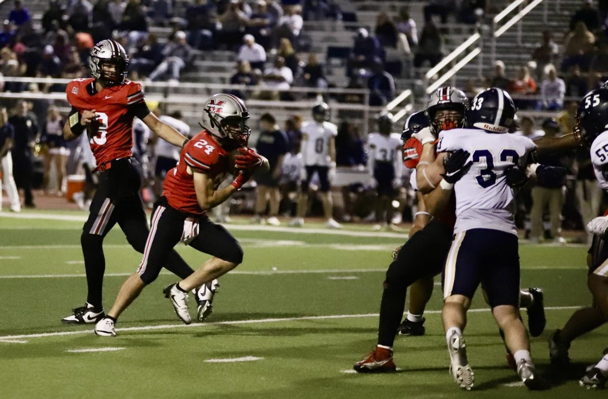 Senior running back Isaiah Keli'ikipi (24) takes the handoff from sophomore quarterback Colton Nussmeier (13) in the first quarter of Marcus' 66-14 victory over Little Elm on November 1, 2024.