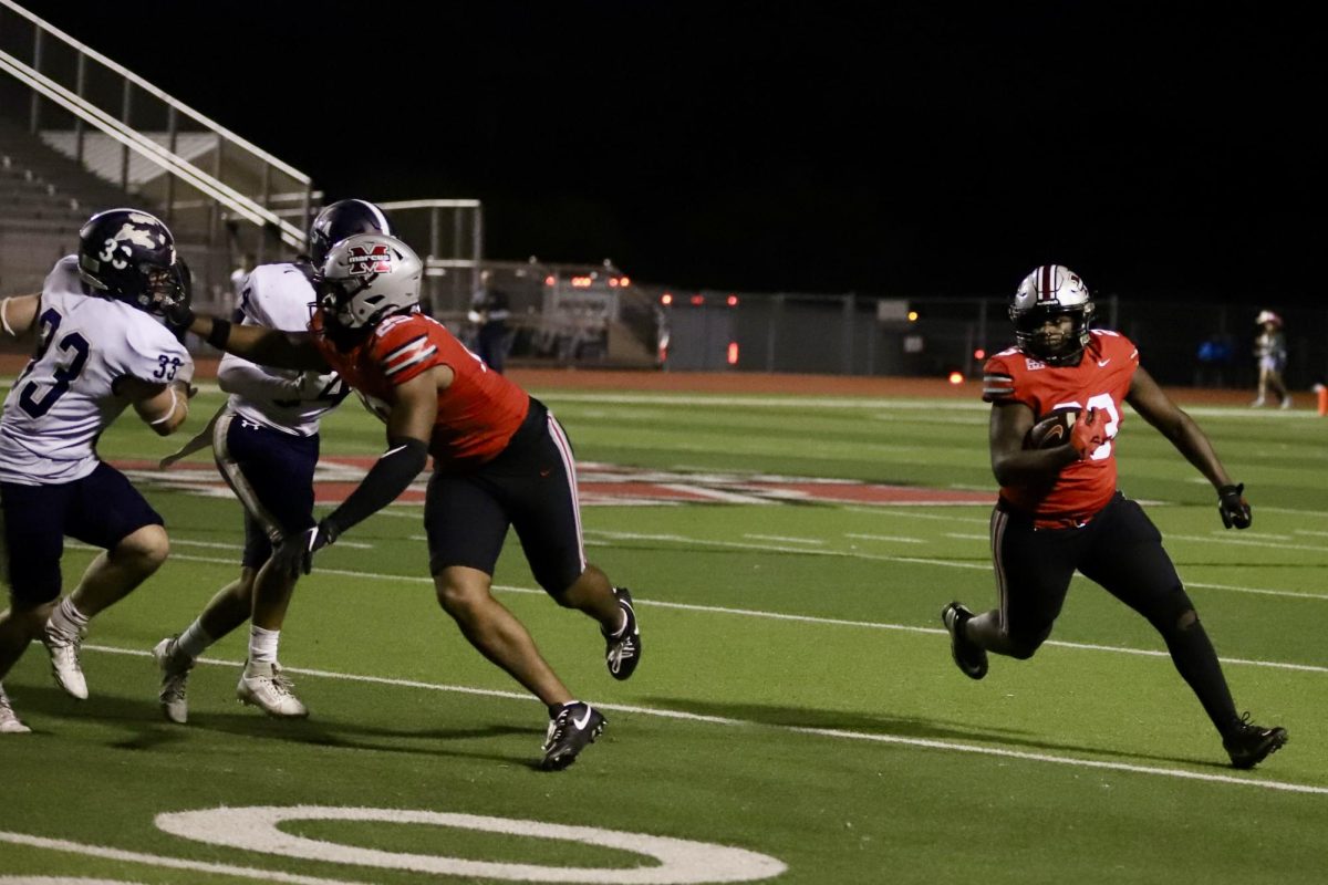 Junior running back Kade McKinght (23) follows the block of senior Arinze Cos-Okpalla (29) in Marcus' 66-14 victory over Little Elm on November 1, 2024.