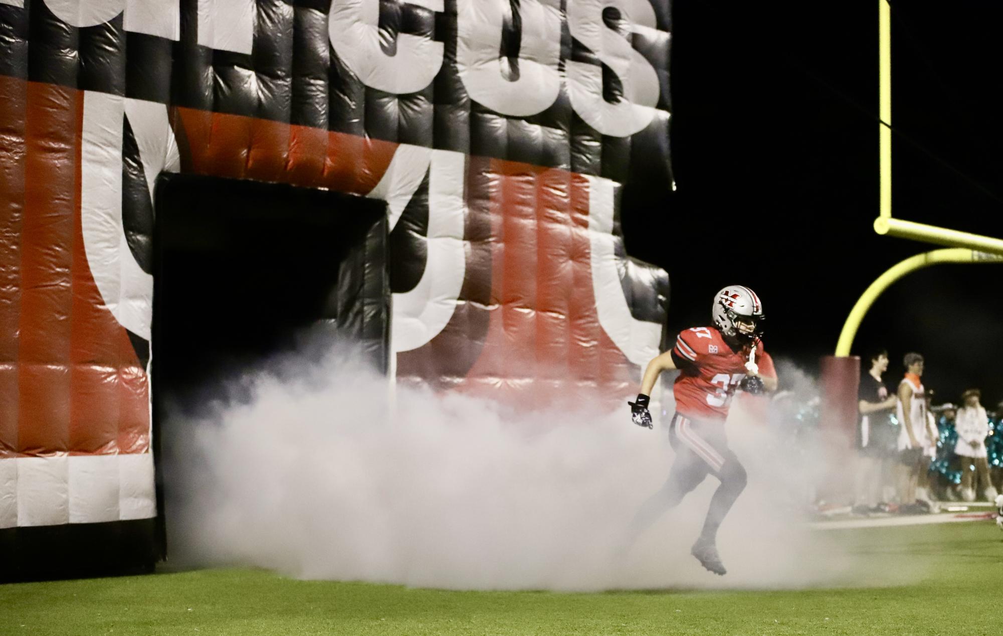 Senior defensive back Cayden Bowie (37) sprints out of the run-through tunnel before Marcus' 66-14 victory over Little Elm on November 1, 2024. 