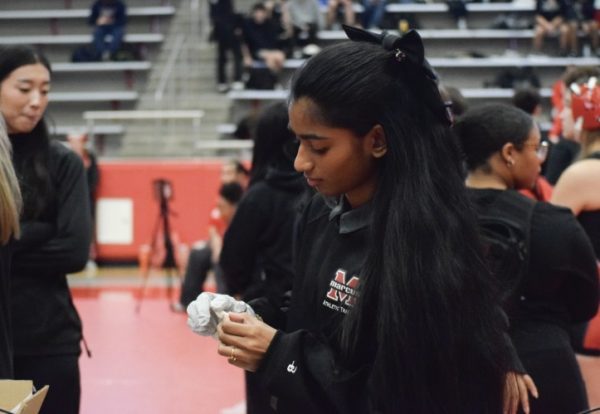 Saavni preps nose plugs for athletes at the district wrestling tournament.